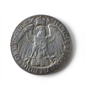 Round silver coin with a crowned heraldic eagle, outstretched wings, and a necklace, encircled by edge inscriptions.