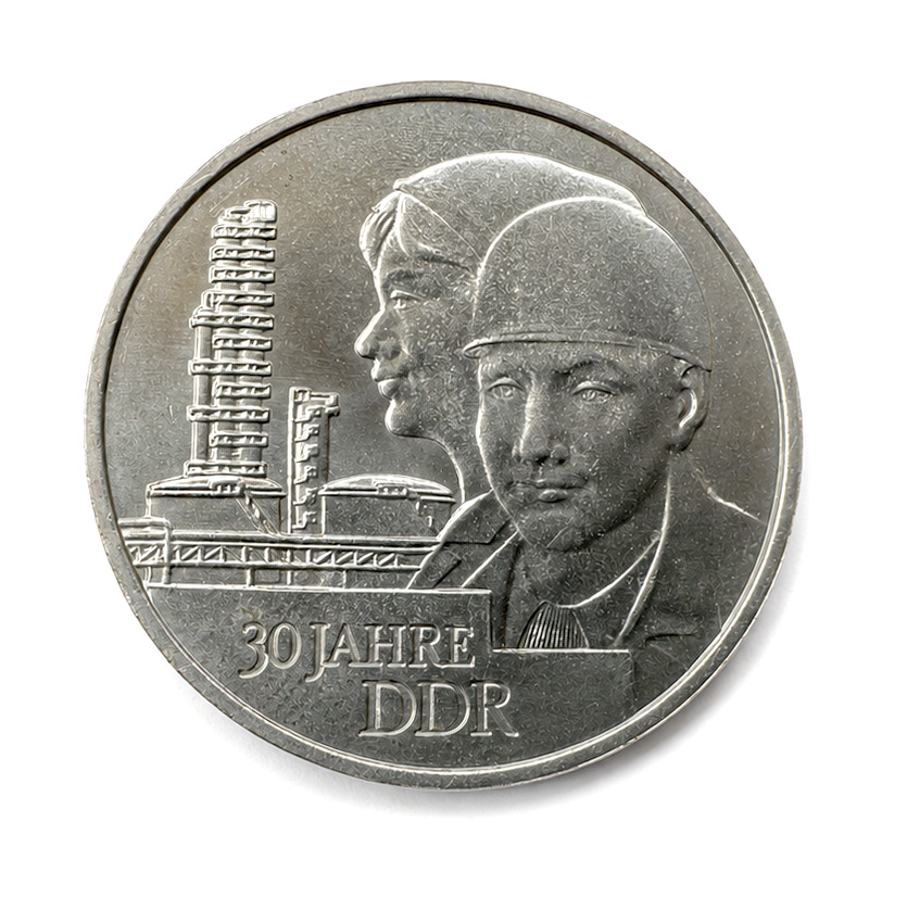 Commemorative DDR coin: '30 Jahre DDR' with industrial skyline and two workers' portraits.