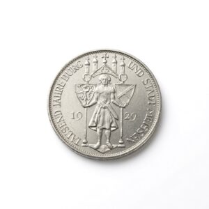 Silver coin showing an armored knight holding two shields, year 1929, with circular inscription around the edge (informative).