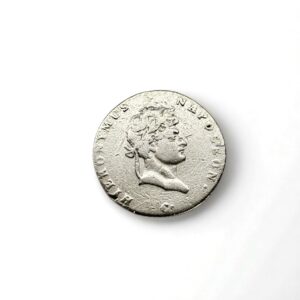 Silver coin featuring a right-facing bust of a man with a laurel, surrounded by raised inscriptions along the edge on a white background.